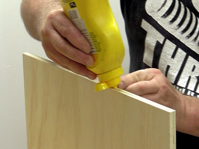 applying glue to the edge of the panel